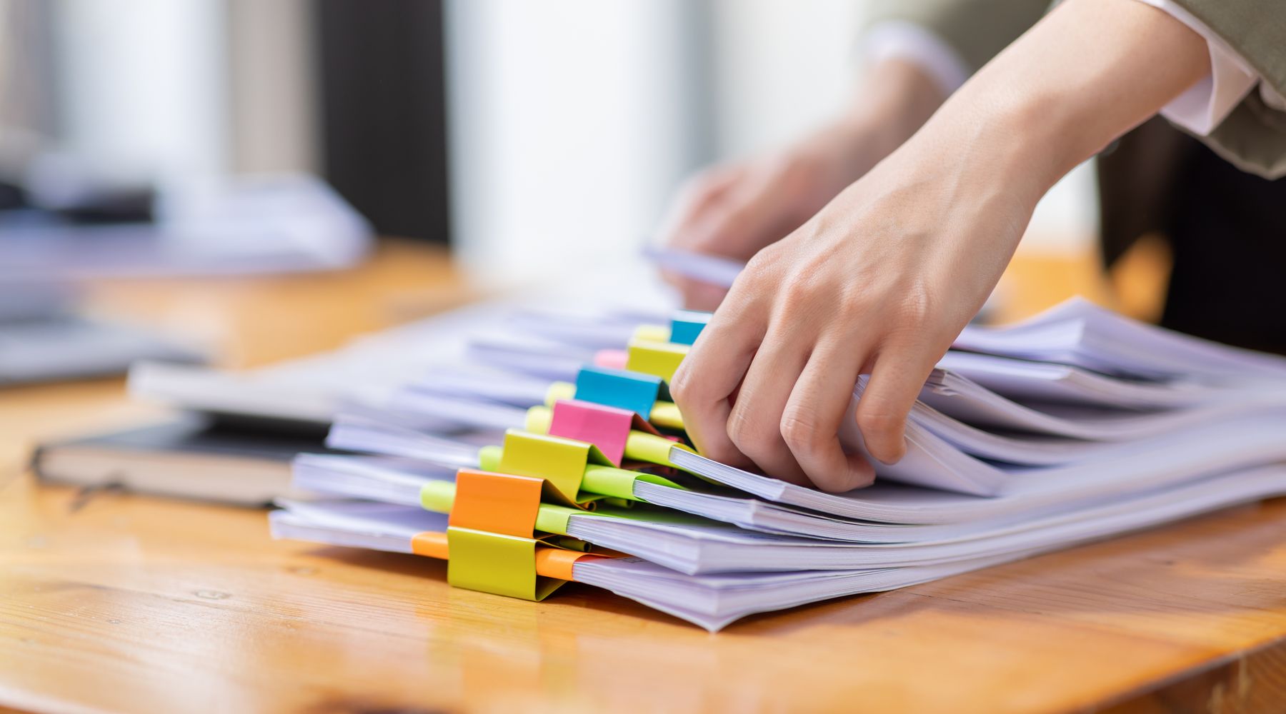 Tabbed stacks of documents on a desk
