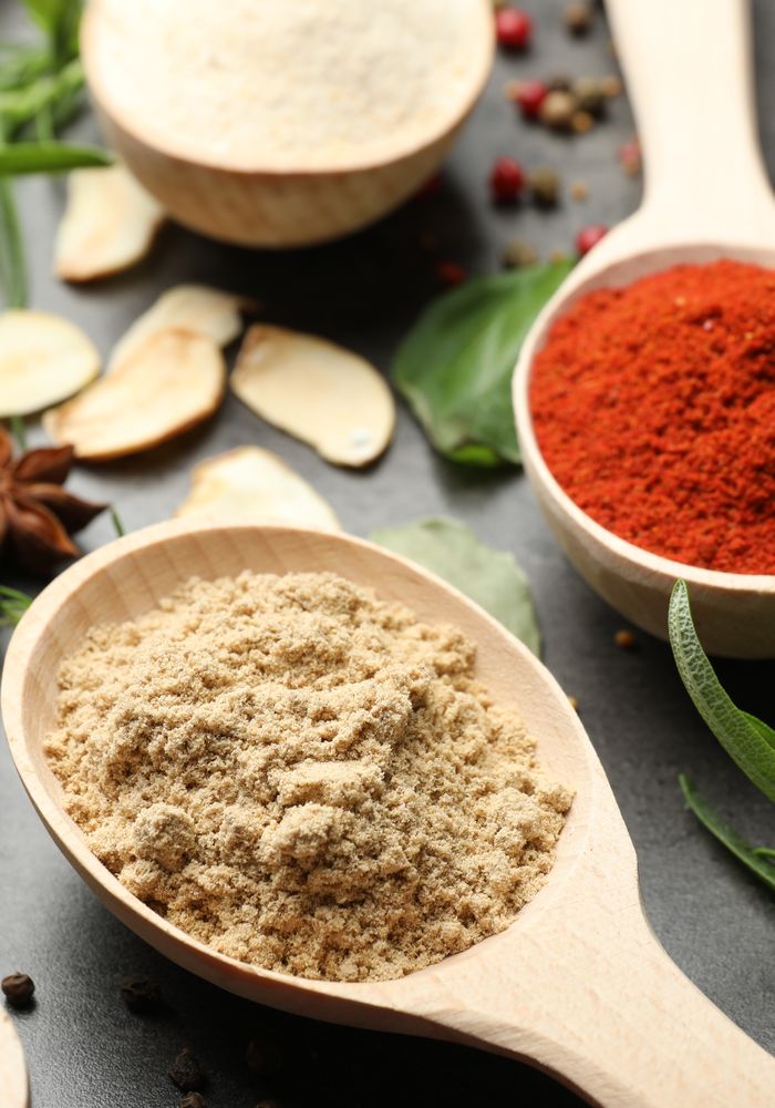 Ground spices and wooden spoons